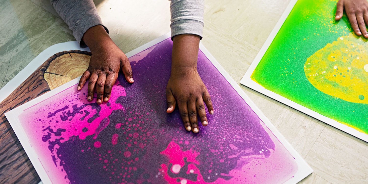 Student's hands working with sensory mats.